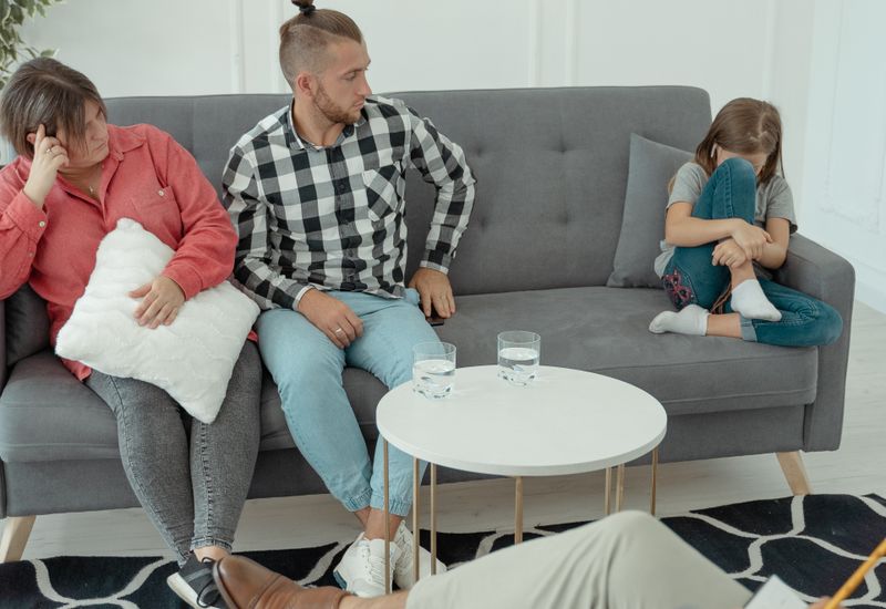 A family and their therapist during a counselling session at home