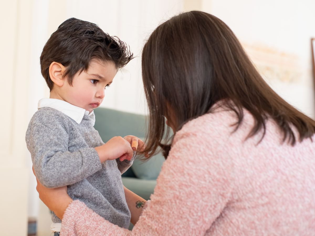 A parent talking gently with a young child at home