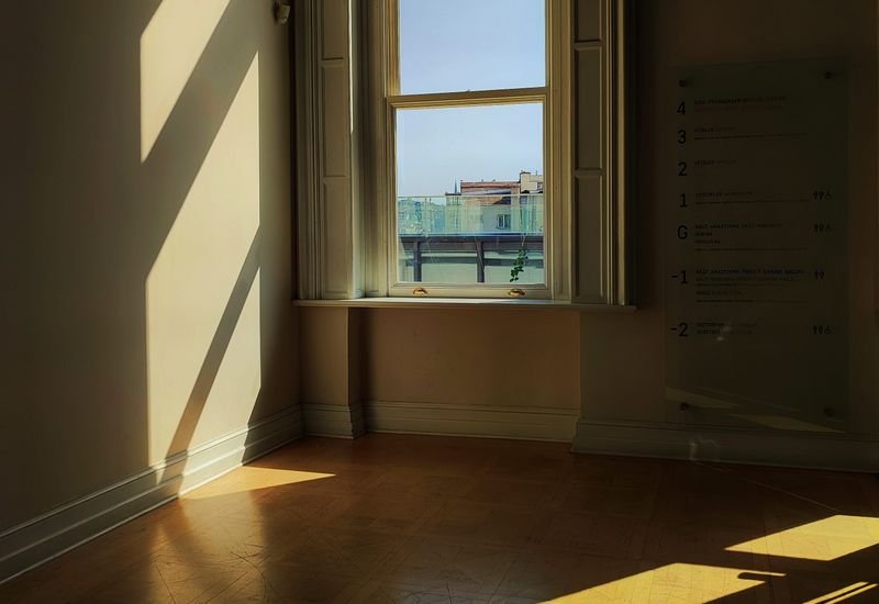 Morning light falling across the floor of a quiet, empty room